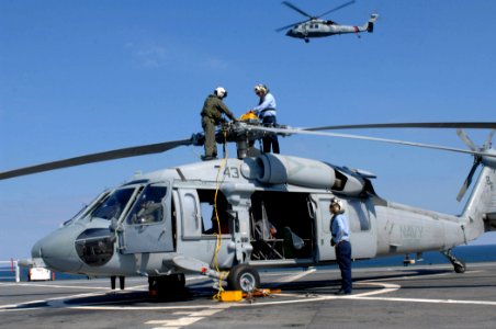 US Navy 071014-N-7088A-065 Members attached to Helicopter Sea Combat Squadron (HSC) 28, secure the propeller on an MH-60S Seahawk aboard Military Sealift Command hospital ship USNS Comfort (T-AH 20)