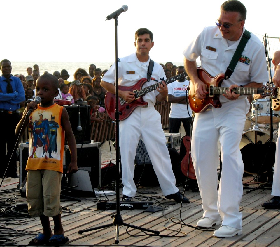 US Navy 071021-N-0000X-002 A Congolese child makes an impromptu appearance during a performance by The Diplomats, the Commander, Naval Forces Europe (CNE) Band, to lead the crowd in a call and response song