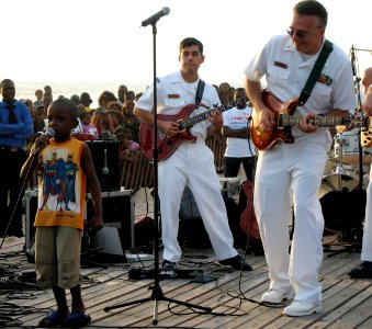 US Navy 071021-N-0000X-002 A Congolese child makes an impromptu appearance during a performance by The Diplomats, the Commander, Naval Forces Europe (CNE) Band, to lead the crowd in a call and response song