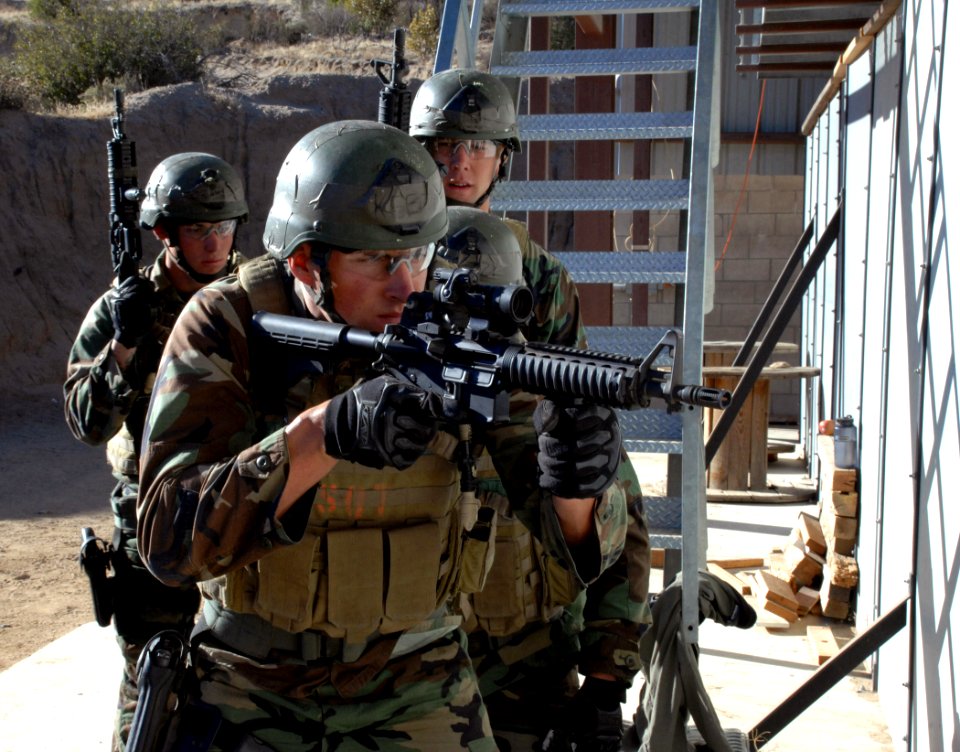 US Navy 071019-N-6552M-024 A team of four SEAL trainees prepare to breach a room during a SEAL qualification training exercise