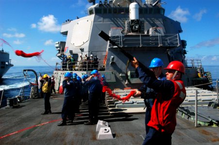 US Navy 071016-N-4014G-091 Gunners Mate 2nd Class Peter Bay fires a shot line from the foc'sle of guided-missile destroyer USS Porter (DDG 78) to the British auxiliary oiler RFA Bayleaf (A109) to begin an underway replenishment