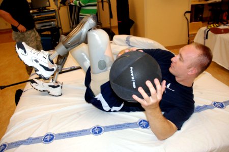 US Navy 071015-N-5086M-211 Air Force Capt. David K. Berling performs abdominal training with a medicine ball during routine therapy in the new Comprehensive Combat and Complex Casualty Care (C5) at Naval Medical Center San Dieg photo