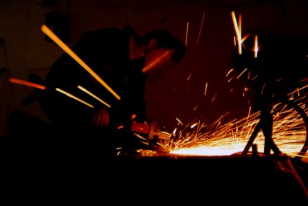US Navy 071017-N-2659P-018 Mass Communication Specialist 3rd Class Philip Morrill removes floor brackets with a circular grinder as part of a berthing overhaul aboard the Nimitz-class aircraft carrier USS John C. Stennis (CVN 7