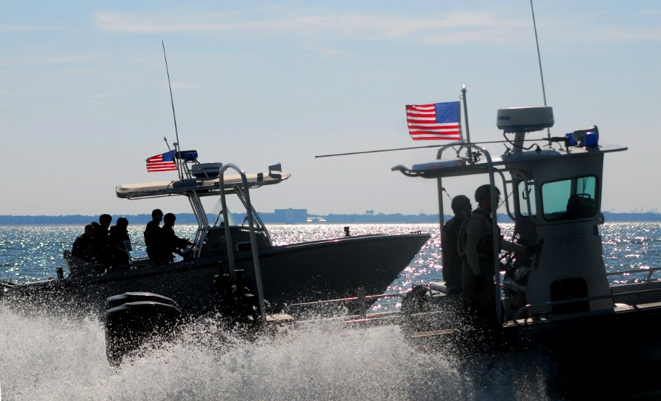 US Navy 071015-N-8907D-314 Sailors aboard high-speed security boats pursue mock targets while enforcing a 450-yard safety zone during port security training with the Center for Security Forces Command