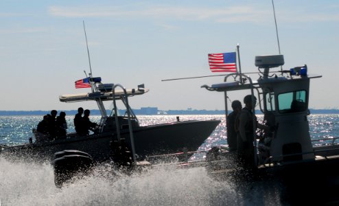 US Navy 071015-N-8907D-314 Sailors aboard high-speed security boats pursue mock targets while enforcing a 450-yard safety zone during port security training with the Center for Security Forces Command