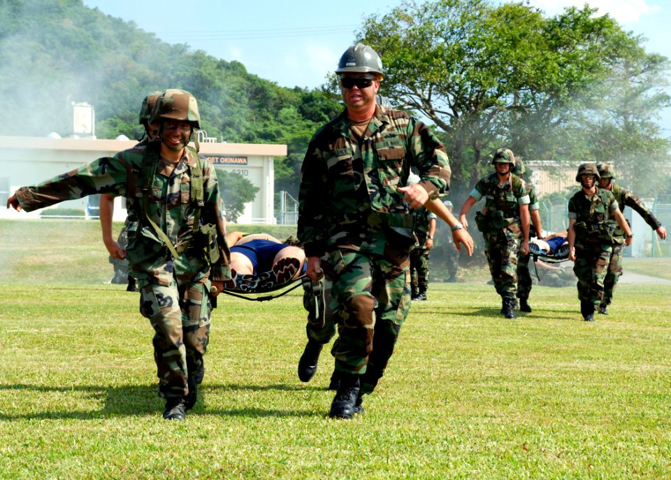US Navy 071022-N-1120L-066 Newly trained combat life savers prove their skills while transporting a simulated injured service member on a stretcher during a mass casualty drill