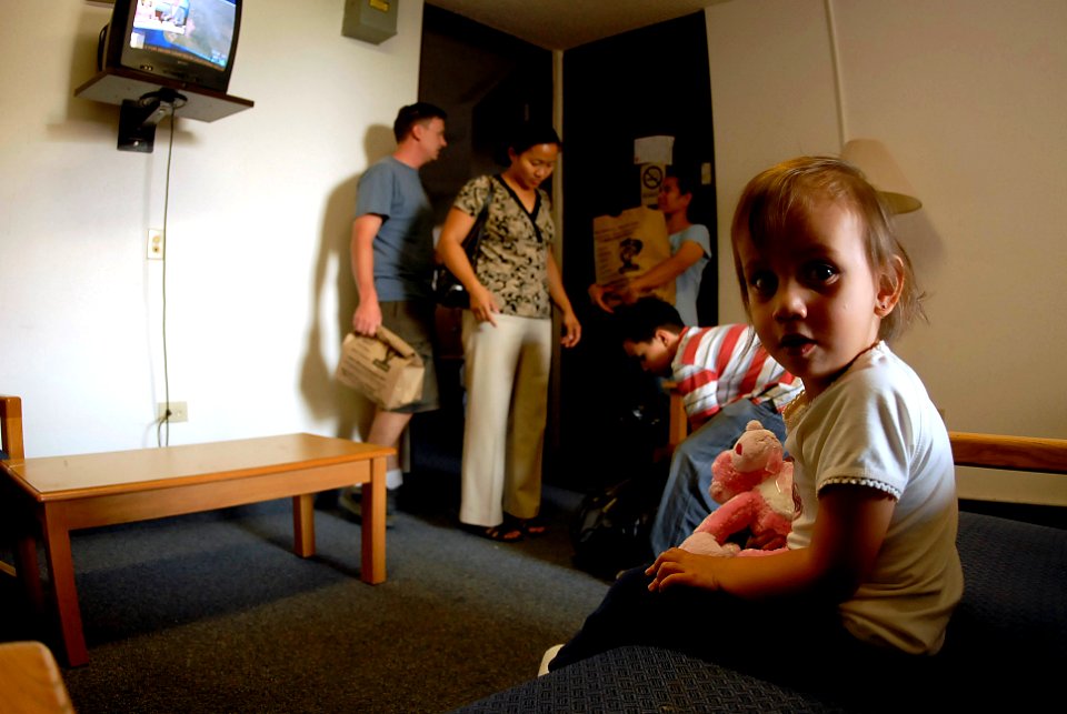 US Navy 071023-N-4776G-153 Ensign Nelson Mozzin, an officer on board USS Ronald Reagan (CVN 76), and his family take refuge in the naval barracks on Naval Air Station Coronado