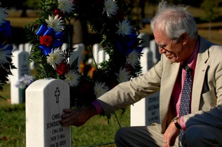 US Navy 071021-N-2653P-149 Daniel Murphy, father of Navy SEAL Lt. Michael Murphy touches the gravestone of Army Chief Warrant Officer 4 Chris J. Scherkenbach, during a visit to Arlington National Cemetery