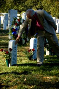 US Navy 071021-N-5319A-040 Daniel Murphy, father of Navy SEAL Lt. Michael Murphy touches the gravestone of Electronics Technician 1st Class Jeffrey Lucas, during a visit to Arlington National Cemetery