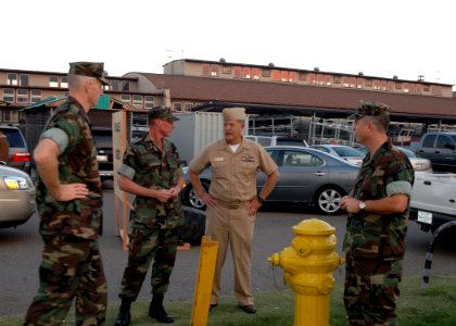 US Navy 071023-N-4973M-015 Capt. Jim Wink, commanding officer of Amphibious Construction Battalion (ACB) 1, Command Master Chief Damon L. Anthony and Lt. Joseph Roach, a Navy chaplain, discuss disaster relief efforts photo