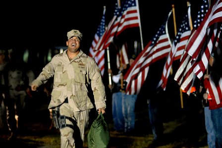 US Navy 071022-N-4515N-146 Quarter Master 2nd Class Nikolas Appel runs out to greet his wife and child following a 7 month deployment to Iraq with Riverine Squadron (RIVRON) 1
