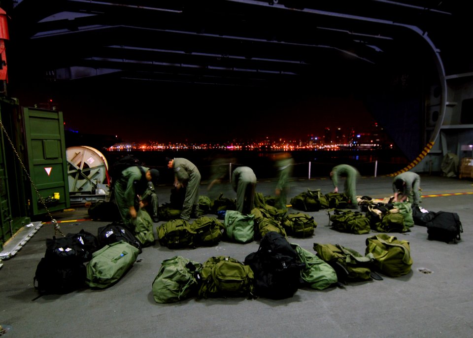 US Navy 071022-N-7981E-009 Members of Helicopter Visit Board Search Seizure (HVBSS) Team 1 ready their gear for a non-compliant boarding exercise during the early morning hours aboard the Nimitz-class aircraft carrier USS Abrah