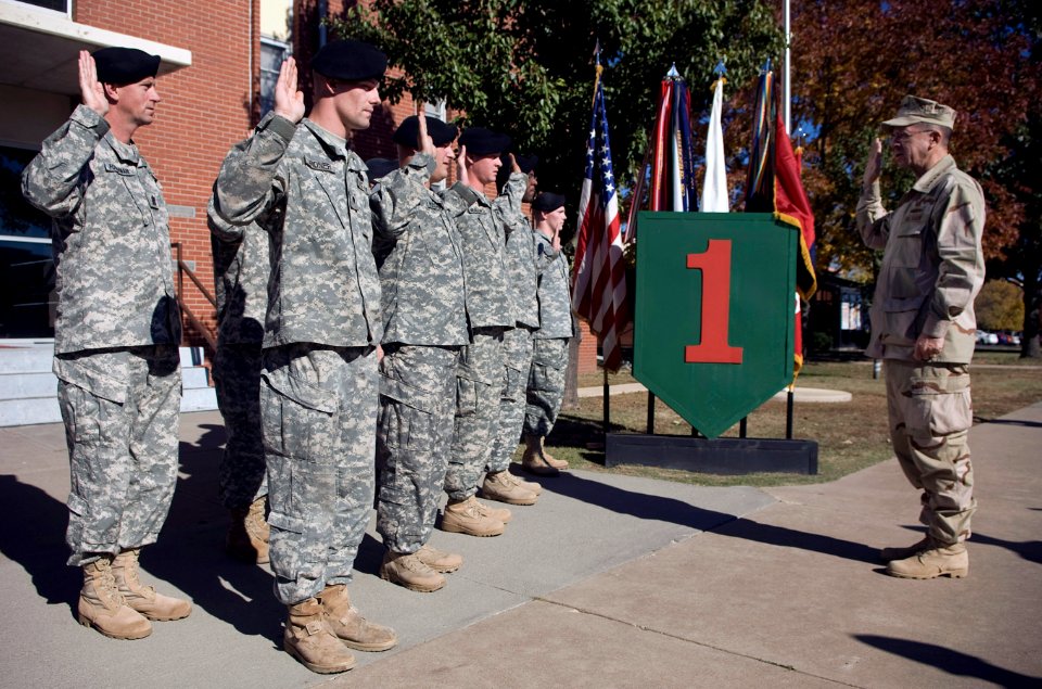 US Navy 071024-N-0696M-195 Chairman of the Joint Chiefs of Staff, Adm. Mike Mullen reenlists nine members of the 1st Infantry Division stationed at Fort Riley