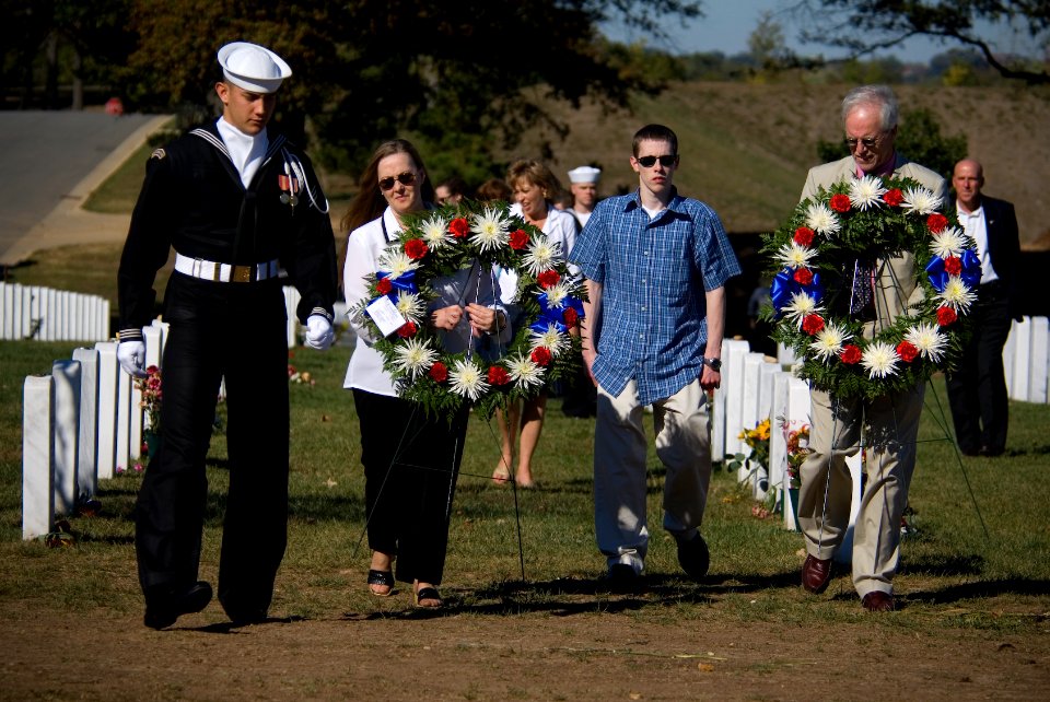 US Navy 071021-N-5319A-013 During a visit to Arlington National Cemetery, family members of Navy SEAL Lt. Michael Murphy carry wreaths to lie at the gravestones of service members killed by the same enemy forces as their son