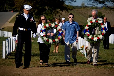 US Navy 071021-N-5319A-013 During a visit to Arlington National Cemetery, family members of Navy SEAL Lt. Michael Murphy carry wreaths to lie at the gravestones of service members killed by the same enemy forces as their son