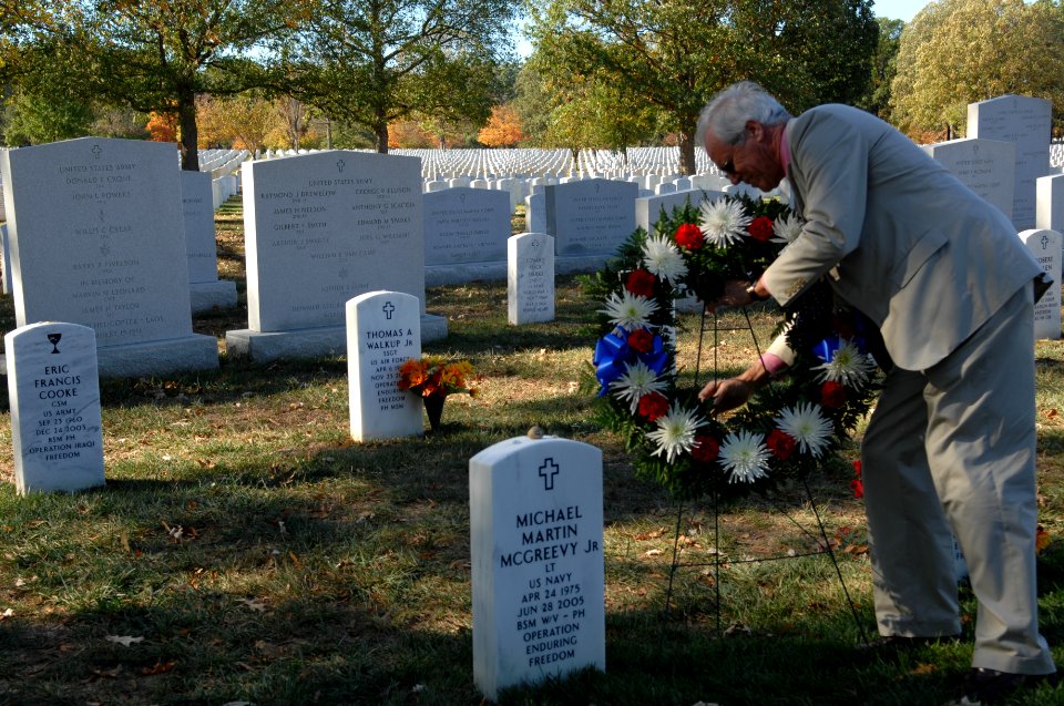 US Navy 071021-N-2653P-249 Daniel Murphy, father of Navy SEAL Lt. Michael Murphy lays a wreath at the grave of Navy Lt. Michael McGreevy, during a visit to Arlington National Cemetery