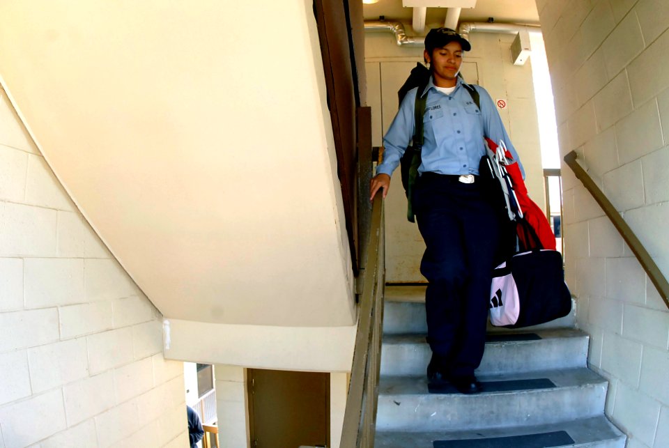 US Navy 071023-N-4776G-215 Storekeeper Seaman Cristina Aaraosflores moves her belongings from her barracks room at Naval Station North Island to USS Ronald Reagan (CVN 76) to give evacuees from San Diego County a place to stay