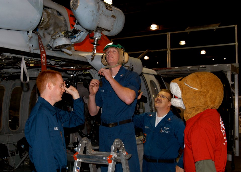 US Navy 071019-N-9860Y-002 The Washington State University mascot, Butch, visits a maintenance crew working on a MH-60S Seahawk Search and Rescue helicopter