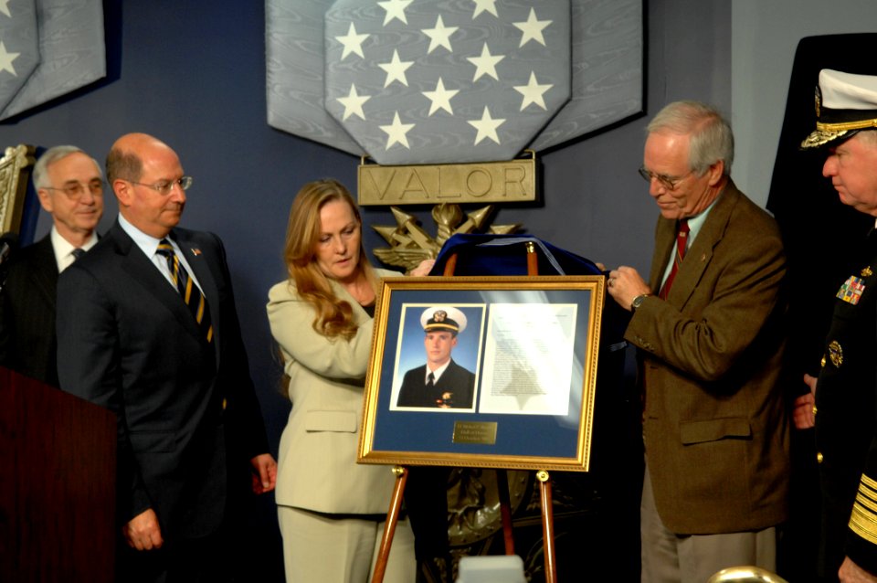 US Navy 071023-N-2653P-389 Daniel and Maureen Murphy, the parents of Navy SEAL Lt. Michael Murphy, unveil a photo of their son during a ceremony held at the Hall of Heroes inside the Pentagon