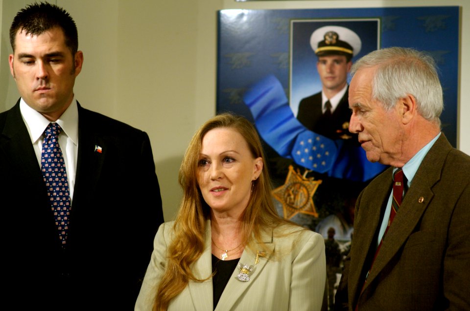 US Navy 071023-N-5319A-067 Navy SEAL Marcus Luttrell stands beside Daniel and Maureen Murphy, the parents of Navy SEAL Lt. Michael Murphy, as they are interviewed during a tour of the Pentagon
