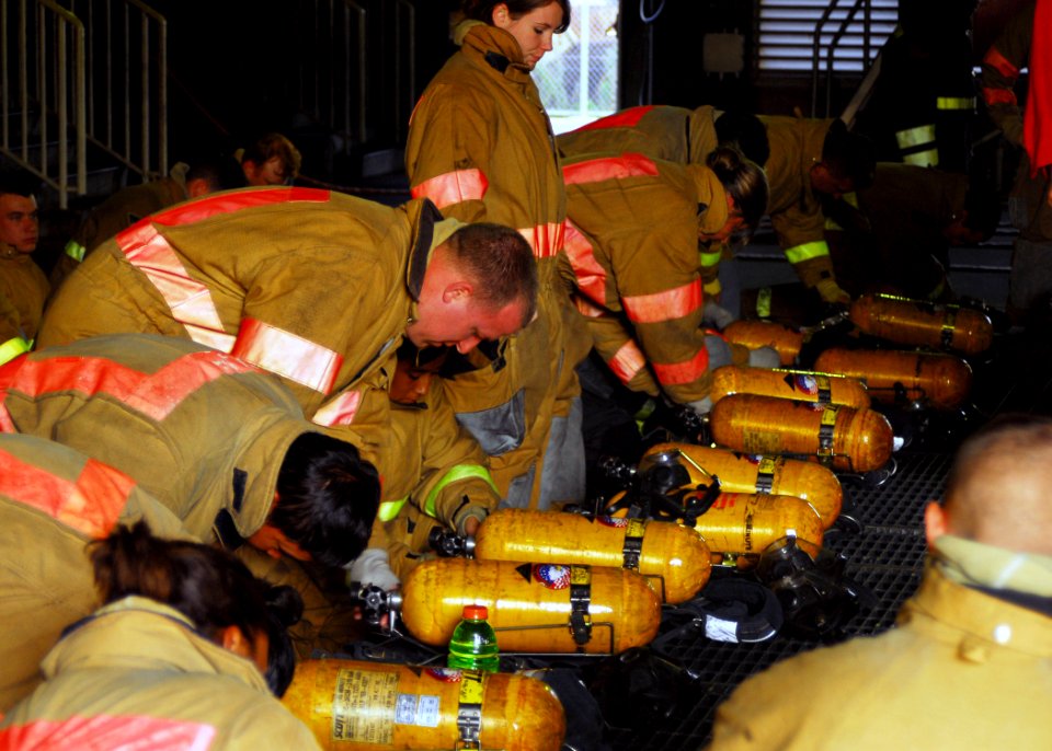 US Navy 071024-N-2638R-007 Sailors assigned to the submarine tender USS Frank Cable (AS 40), prepare their self-contained breathing apparatuses (SCBA) during an advanced shipboard fire fighting class at the Center for Naval Eng
