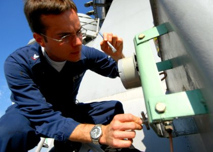US Navy 071022-N-4399G-040 Engineman 3rd Class Christian V. Shields paints a JP5 refueling station gauge on the weather deck of the amphibious command ship USS Blue Ridge (LCC 19)