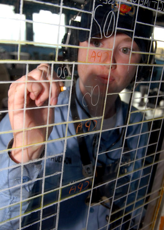 US Navy 071024-N-6710M-004 Operations Specialist Seaman Whitney R. Hudson tracks contacts using the status board in Pilothouse aboard the dock landing ship USS Tortuga (LSD 46)