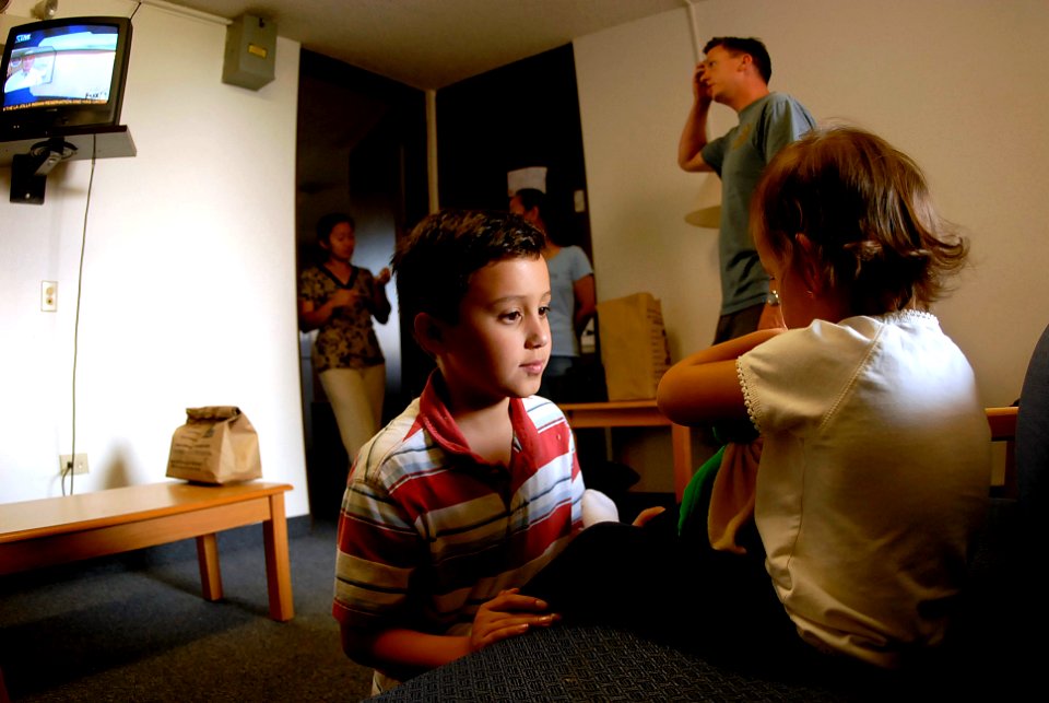 US Navy 071023-N-4776G-142 Ensign Nelson Mozzin, an officer on board USS Ronald Reagan (CVN 76), and his family take refuge in the naval barracks on Naval Air Station Coronado