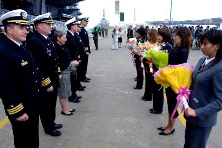 US Navy 071026-N-7883G-039 Commanding officer of USS Kitty Hawk (CV 63), receive flowers during a welcome ceremony for USS Fitzgerald and USS Kitty Hawk