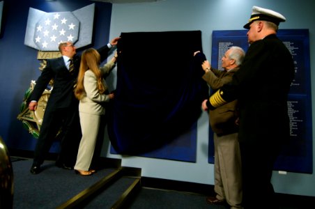 US Navy 071023-N-5319A-216 Secretary of the Navy (SECNAV), the Honorable Dr. Donald C. Winter and Chief of Naval Operations (CNO) Adm. Gary Roughead assist Daniel and Maureen Murphy, the parents of Navy SEAL Lt. Michael Murphy