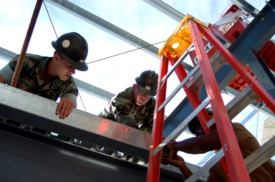 US Navy 071029-N-5253W-002 Seabees from Naval Mobile Construction Battalion (NMCB) 7, Detachment Yokosuka, move a metal beam into place at Fleet Activities Yokosuka