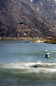 US Navy 071026-N-6597H-045 Two MH-60S Seahawks retrieve water from a lake near a wildfire in San Diego County