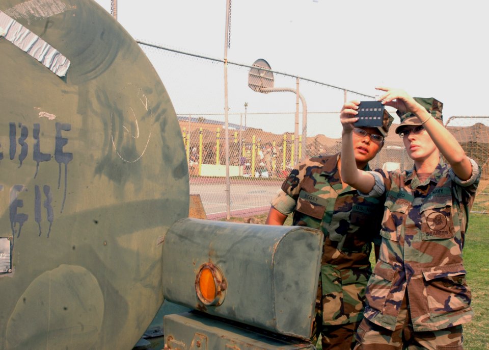 US Navy 071023-N-4973M-018 Hospital Corpsman 2nd Class Ashley Grabo and Seaman Letisha Begay test one of four 400-gallon portable water containers intended for victims of the San Diego wildfires on Turner Field at Naval Amphibi