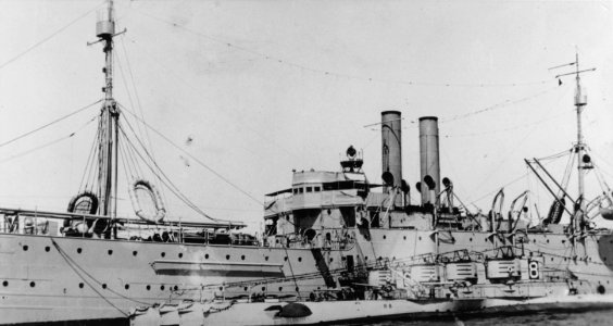 USS Camden (AS-6) with four R-class submarines at San Diego, in the early 1920s (NH 101183)