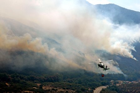 US Navy 071026-N-6597H-090 An MH-60S Seahawk, assigned to Helicopter Sea Combat Squadron (HSC) 85, carries a bucket containing 420 gallons of water to dump on a wildfire in San Diego County