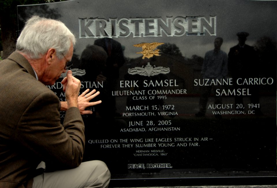US Navy 071024-N-2653P-181 Daniel Murphy, father of SEAL Lt. Michael Murphy, kneels beside the grave of SEAL Lt. Cmdr. Erik Samuel Kristensen at the U.S. Naval Academy
