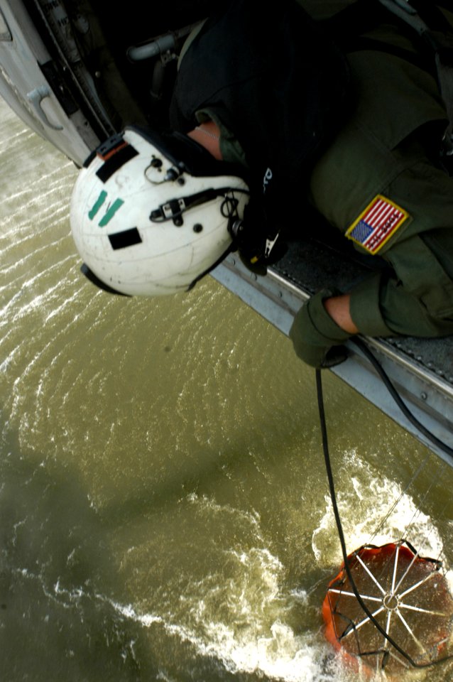 US Navy 071024-N-6597H-109 Aviation Warfare Systems Operator 2nd Class Danny Vickers helps guide pilots while scooping water from a lake near raging wildfires in San Diego County