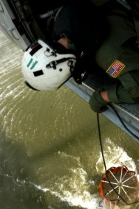 US Navy 071024-N-6597H-109 Aviation Warfare Systems Operator 2nd Class Danny Vickers helps guide pilots while scooping water from a lake near raging wildfires in San Diego County