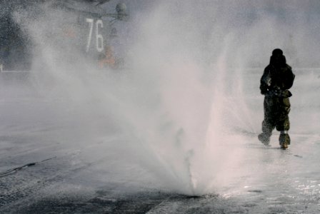 US Navy 071030-N-4133B-158 Sailors attached to the crash and salvage division aboard Nimitz-class aircraft carrier USS Ronald Reagan (CVN 76) participate in a test of the ship's countermeasure washdown and aqueous film forming photo