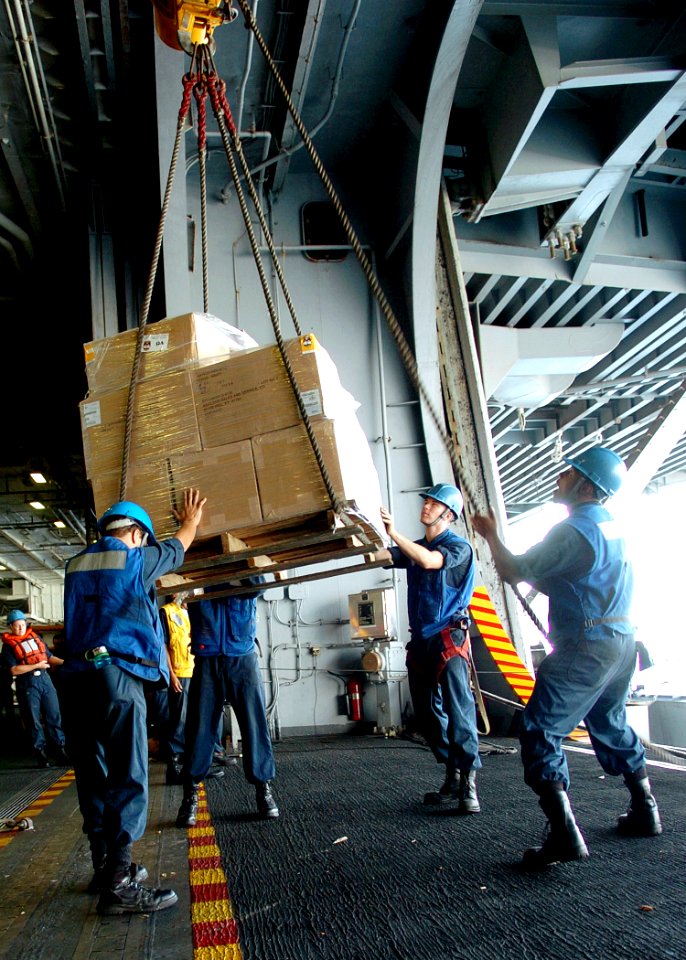 US Navy 071029-N-8132M-095 Deck department personnel unload a pallet of supplies from Military Sealift Command fast combat support ship USNS Supply (T-AOE 6) into the hangar bay