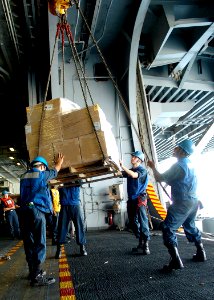 US Navy 071029-N-8132M-095 Deck department personnel unload a pallet of supplies from Military Sealift Command fast combat support ship USNS Supply (T-AOE 6) into the hangar bay