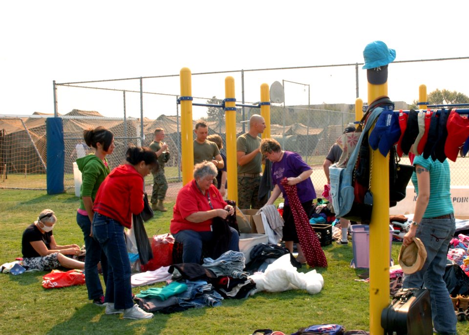 US Navy 071023-N-4973M-022 Evacuees from the San Diego wildfires gather supplies donated by San Diego area high schools on Turner Field at Naval Amphibious Base Coronado