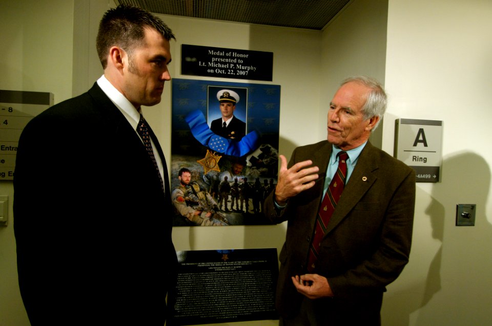 US Navy 071023-N-5319A-060 Daniel Murphy, father of Navy SEAL Lt. Michael Murphy, speaks to former Navy SEAL Marcus Luttrell as they view a display dedicated to Lt. Murphy during a tour of the Pentagon