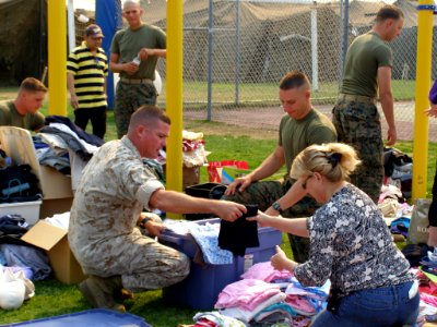 US Navy 071024-N-0000X-056 Evacuees from the San Diego wildfires gather clothing donated by San Diego area high schools on Turner Field at Naval Amphibious Base Coronado photo