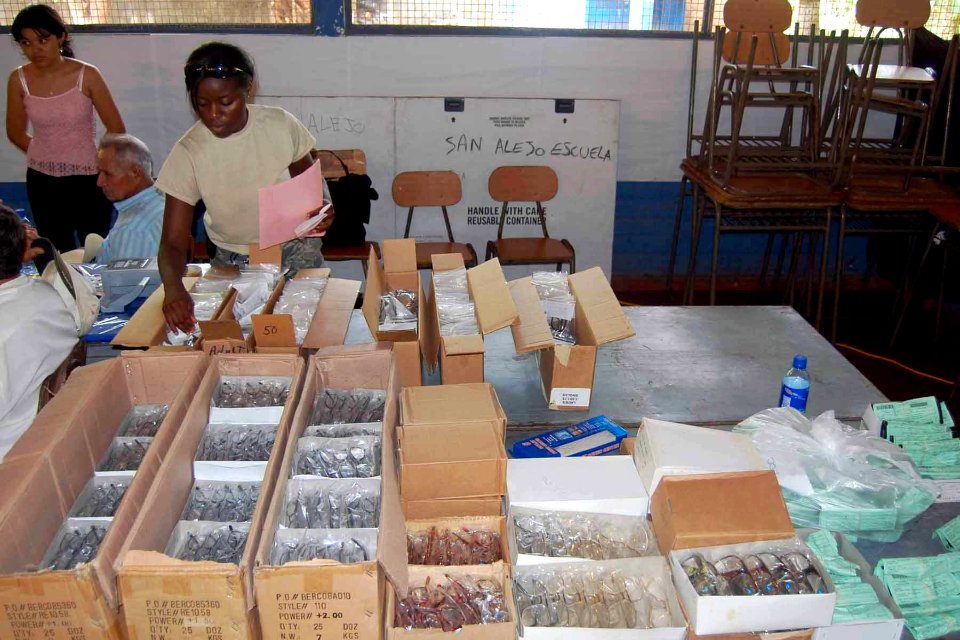 US Navy 090625-F-7522G-002 Airman 1st Class Shaquonique Jones sorts through glasses for an optometry patient during a Continuing Promise 2009 medical community service project