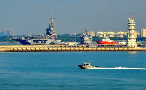 US Navy 090626-N-4774B-048 The aircraft carrier USS Ronald Reagan (CVN 76) and guided-missile cruiser USS Chancellorsville (CG 62) are moored pier side while a Singapore coast guard vessel patrols the area