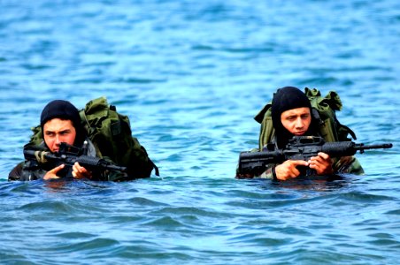 US Navy 090624-N-7883G-034 Basic Underwater Demolition-SEAL (BUD-S) students wade ashore on San Clemente Island during an over the beach exercise photo