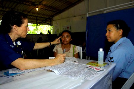US Navy 090629-F-7923S-066 apt. Colleen Gallagher and Religious Programs Specialist 3rd Class Elvira Reyes explain the importance of proper eye maintenance at a primary school in El Carmen