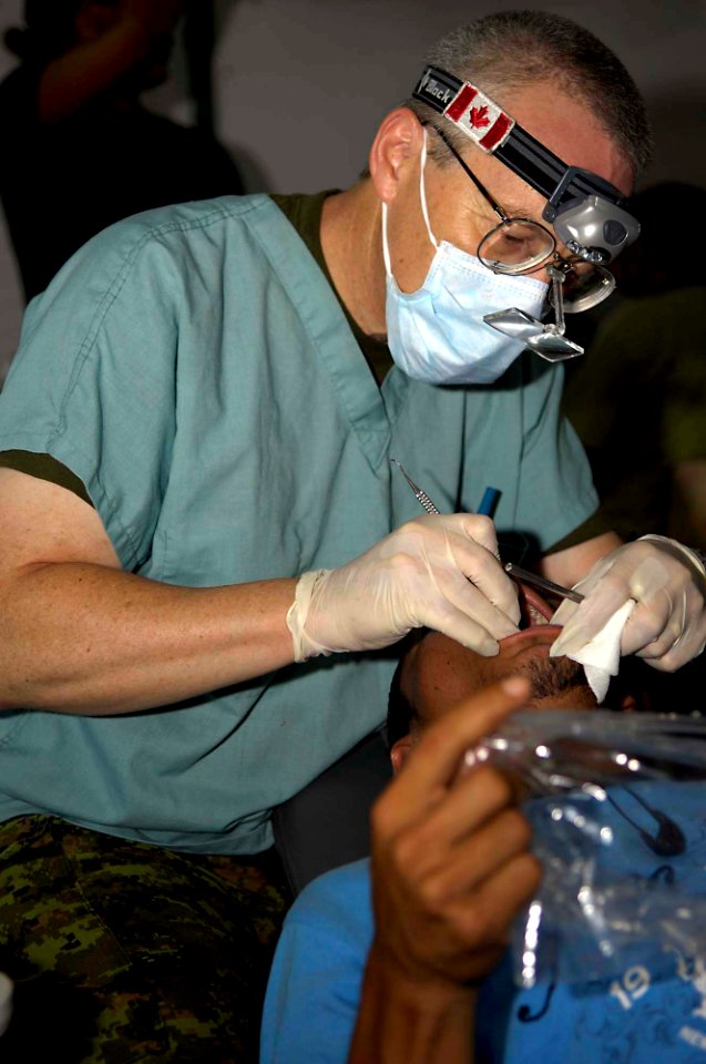 US Navy 090627-F-7923S-069 Maj. Don Trider, a Canadian dentist, provides dental care for a Salvadoran man at Centro Escular Ramon Mendoza school