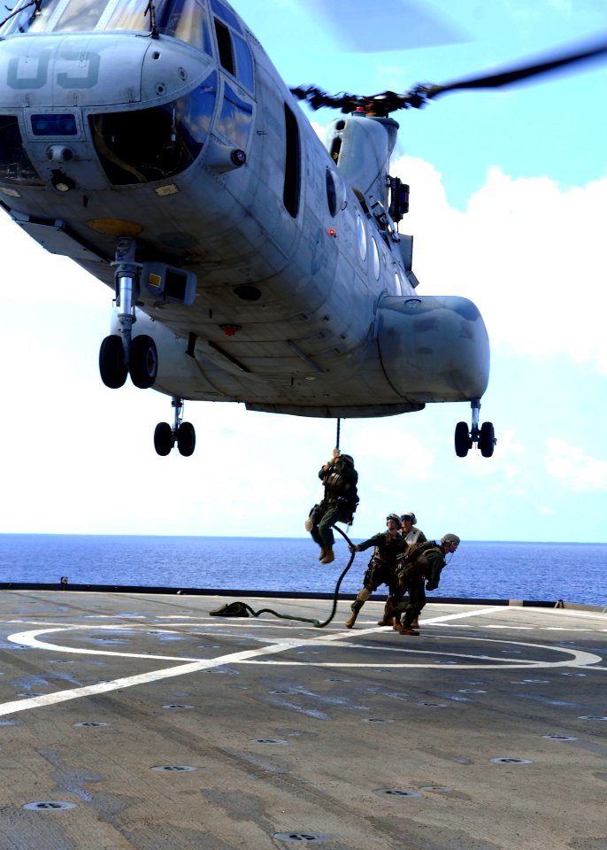 US Navy 090627-N-6692A-057 Marines from the 31st Marine Expeditionary Unit (MEU) fast-rope from a CH-46 Sea Knight helicopter during visit board search and seizure training aboard the amphibious dock landing ship USS Tortuga (L photo